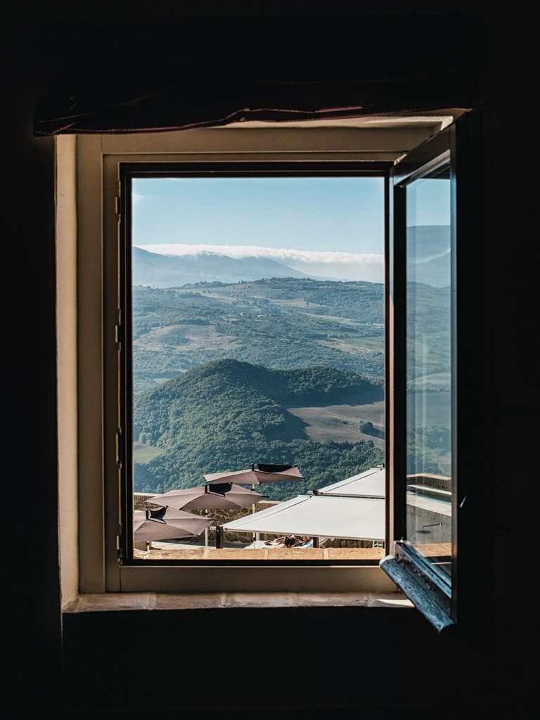 Open window looking out over rolling hills